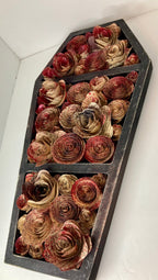 Coffin with blood splattered book roses