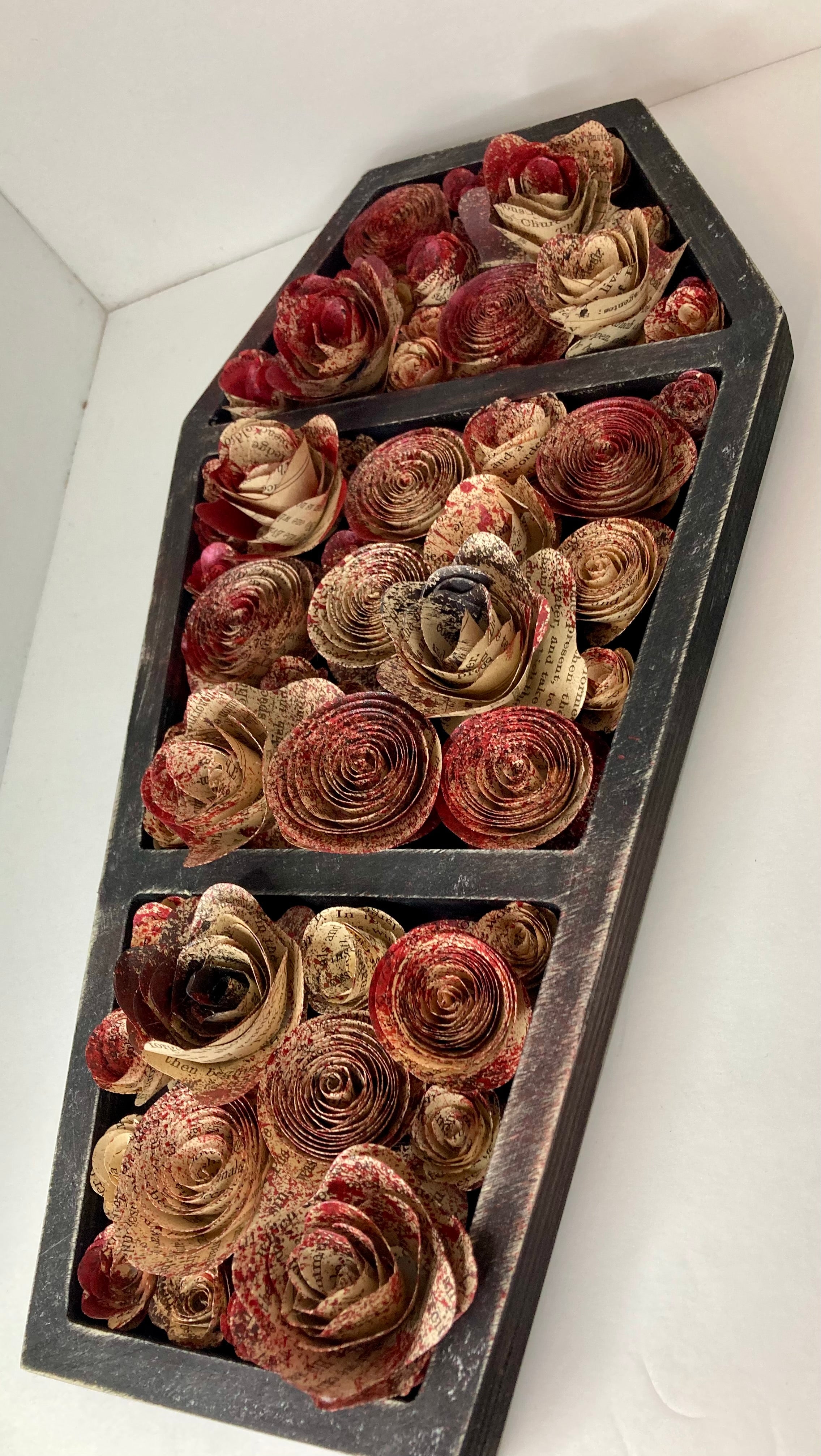 Coffin with blood splattered book roses
