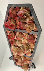 Coffin with blood splattered book roses