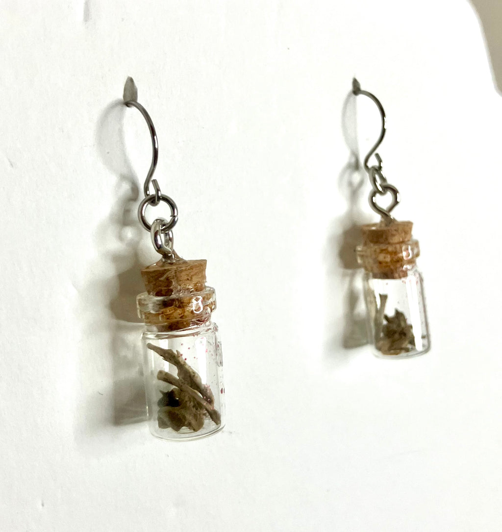 Tiny bone filled vial earrings