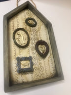 Shadow box houses with small framed bones