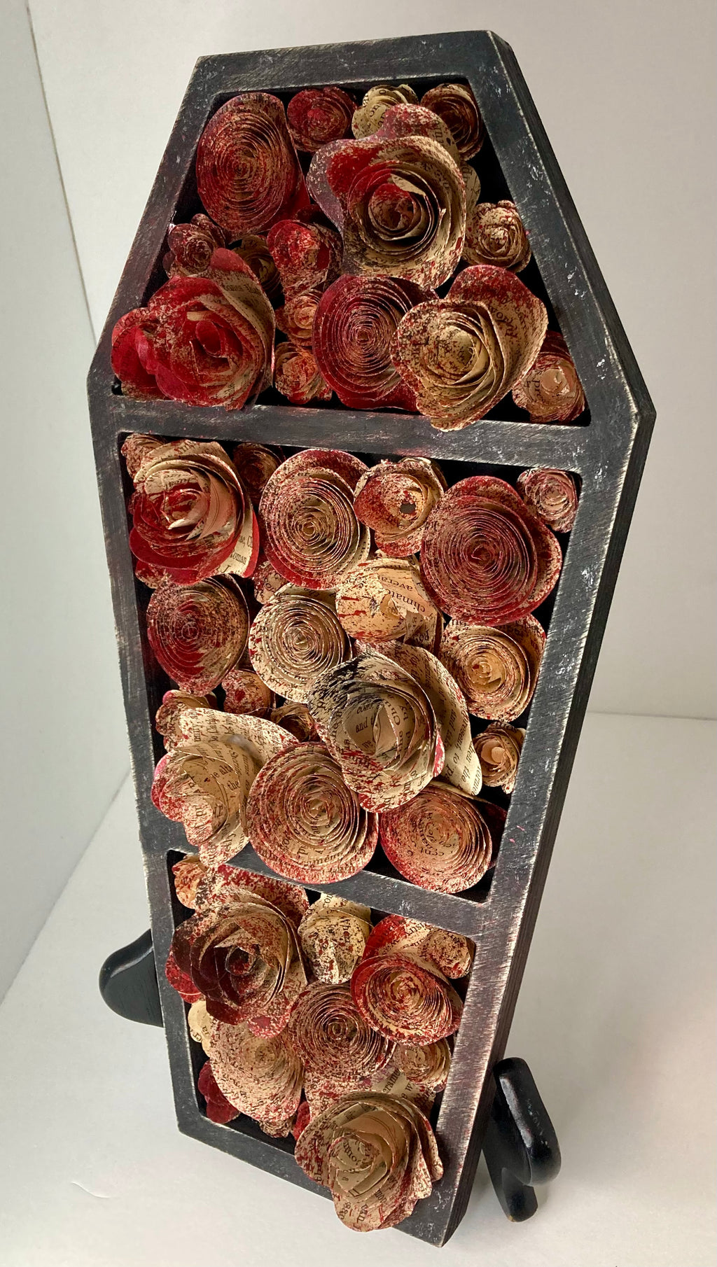 Coffin with blood splattered book roses