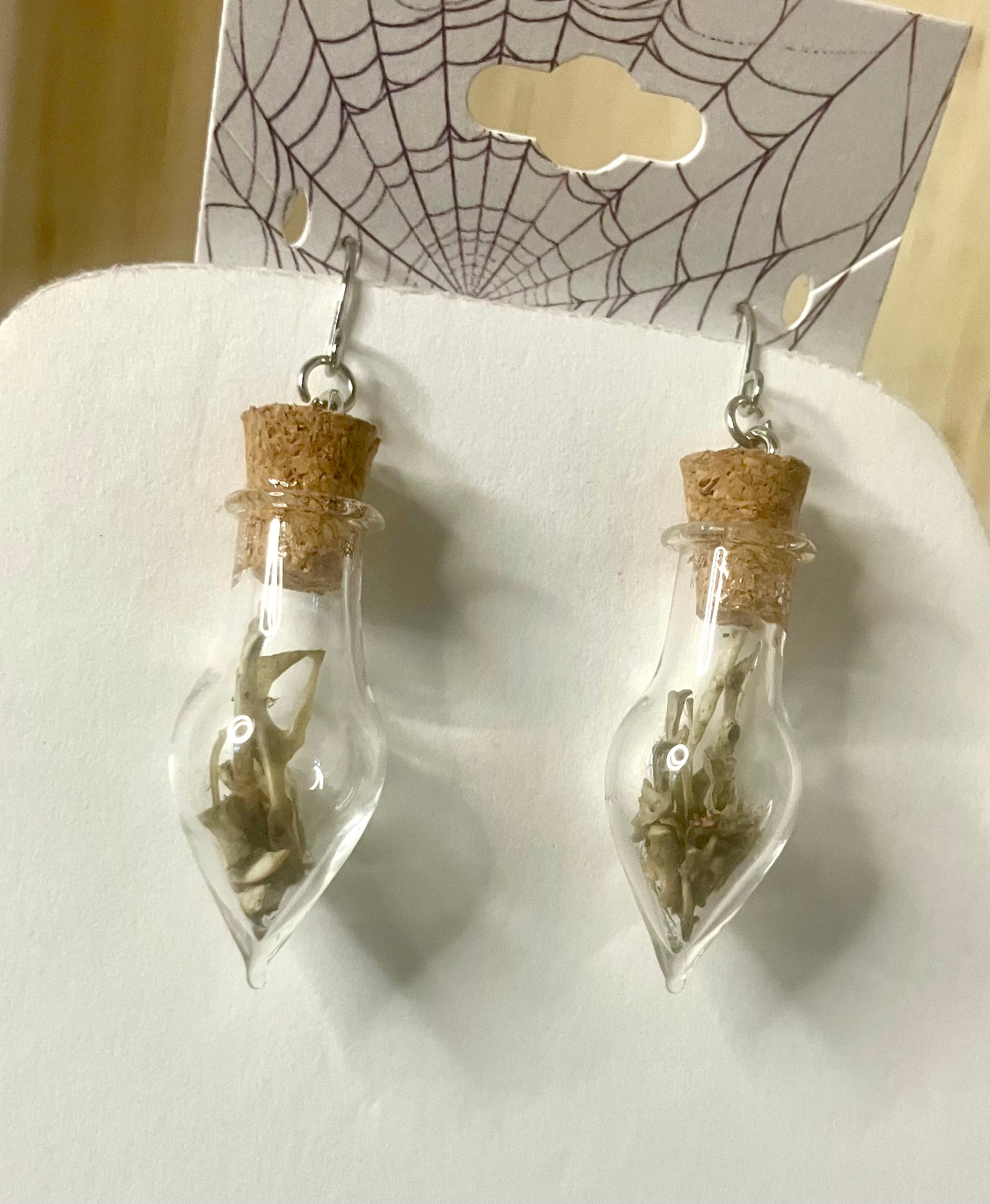 Tiny bone filled vial earrings