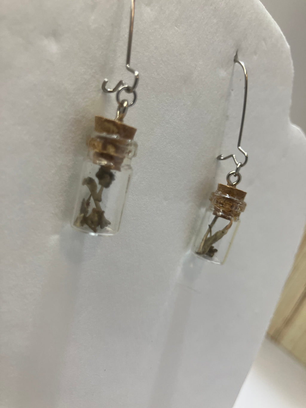 Tiny bone filled vial earrings