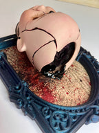 Broken doll art with decorative frame