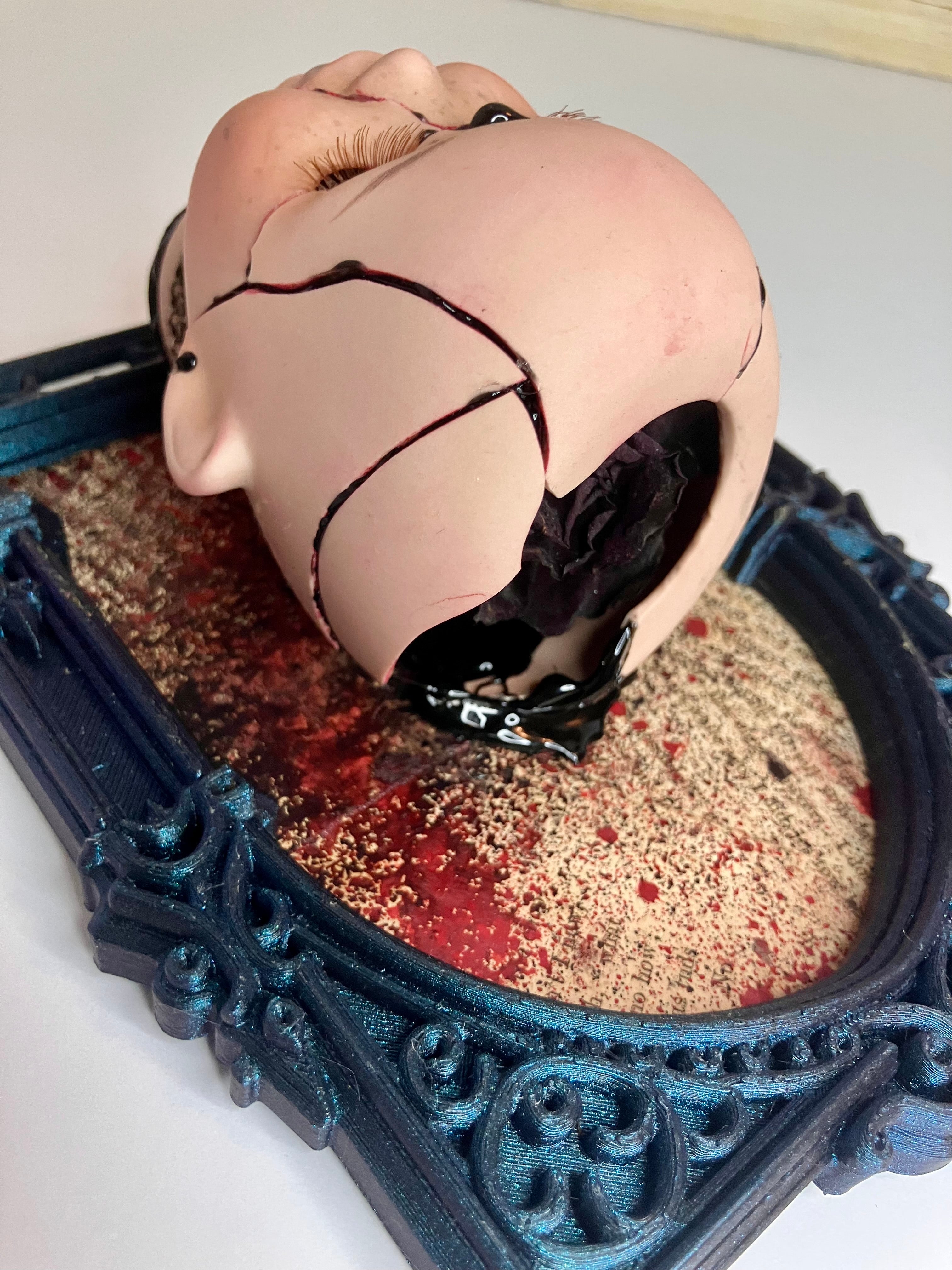 Broken doll art with decorative frame