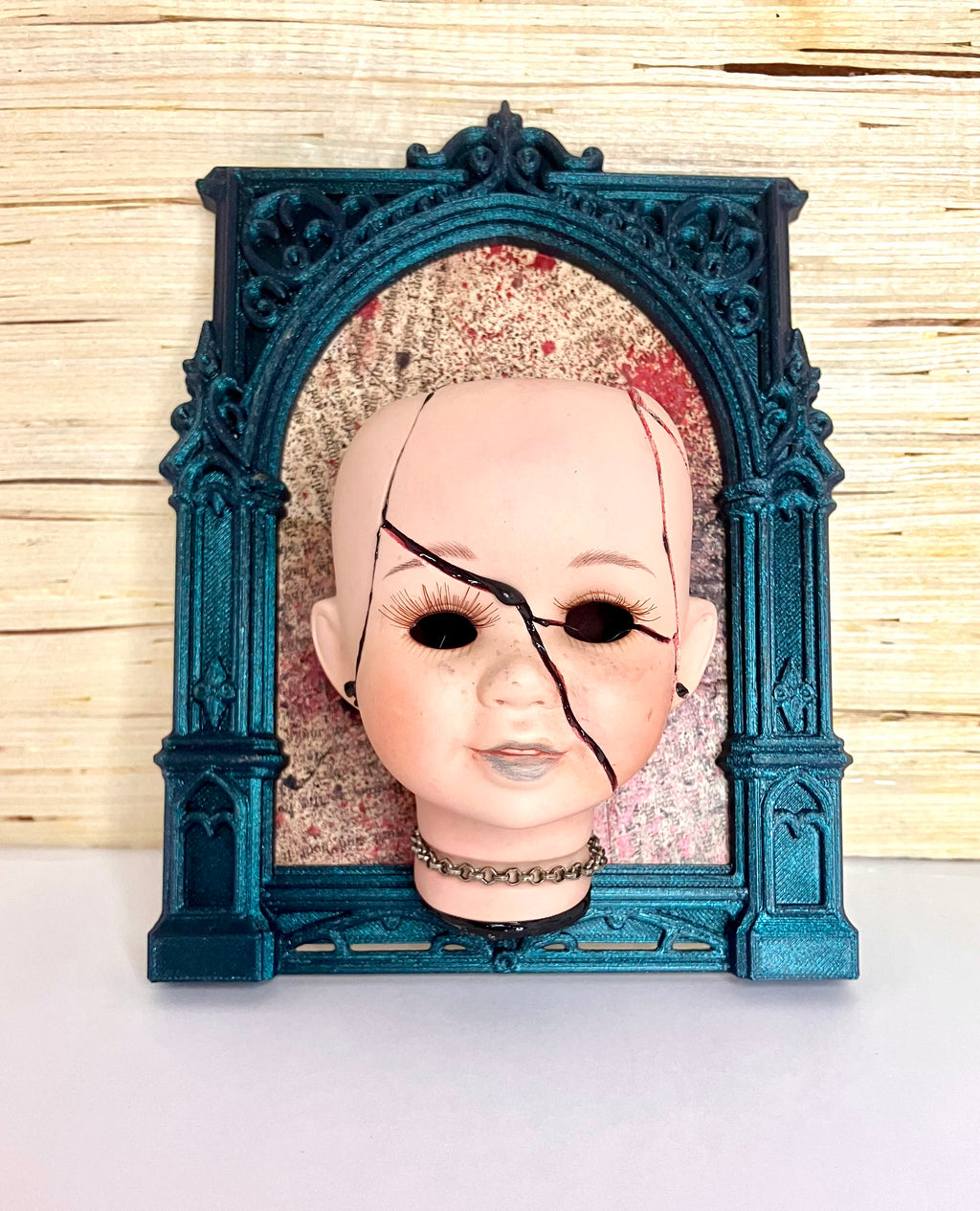 Broken doll art with decorative frame
