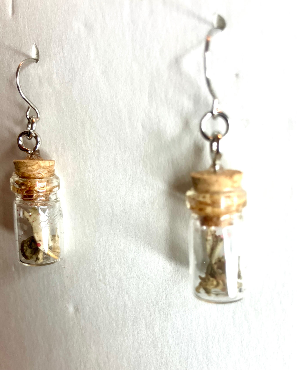 Tiny bone filled vial earrings