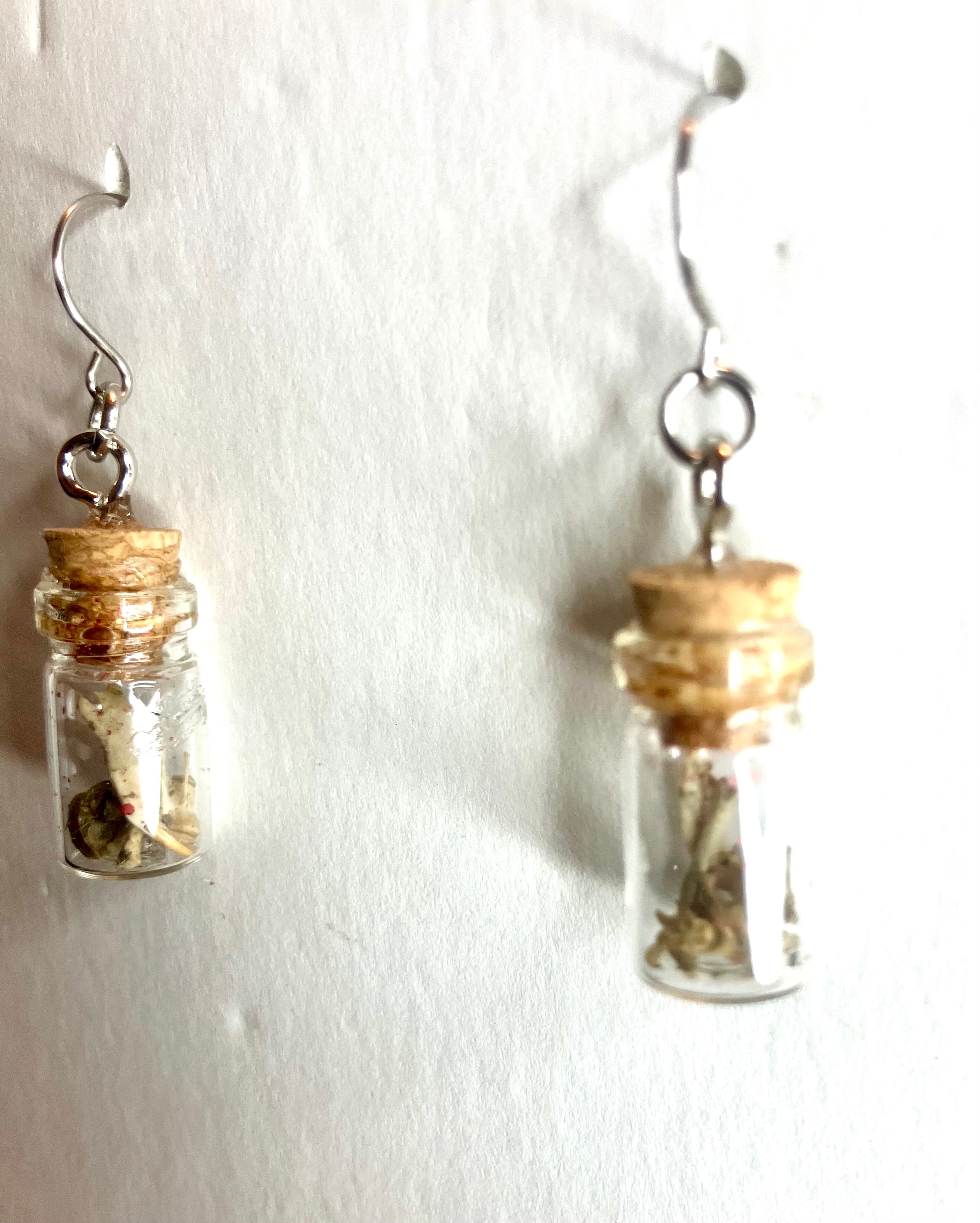 Tiny bone filled vial earrings