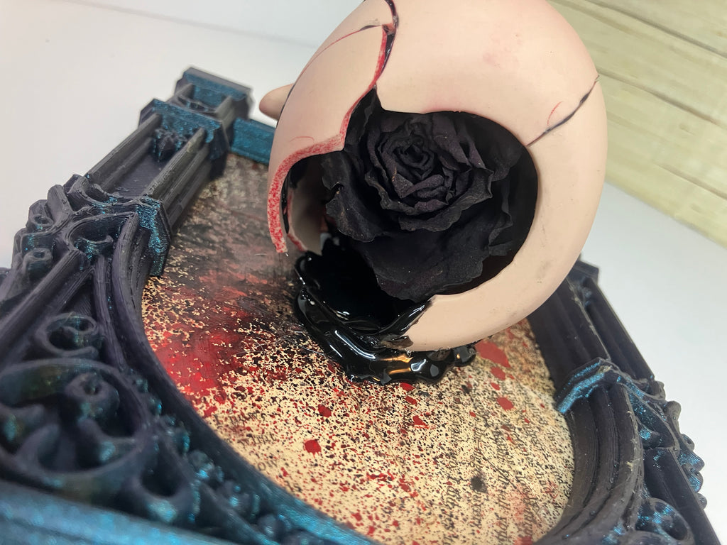 Broken doll art with decorative frame