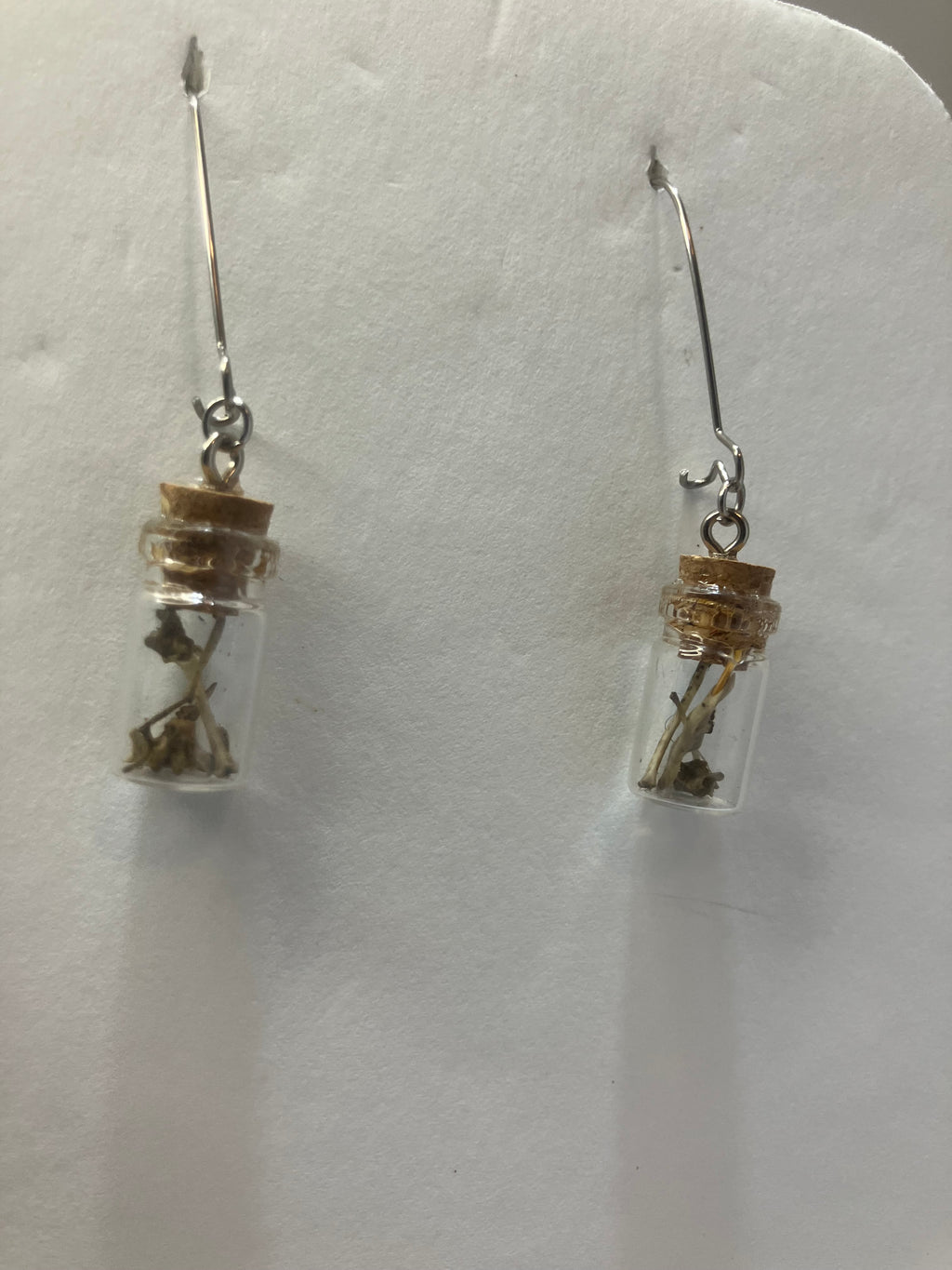 Tiny bone filled vial earrings