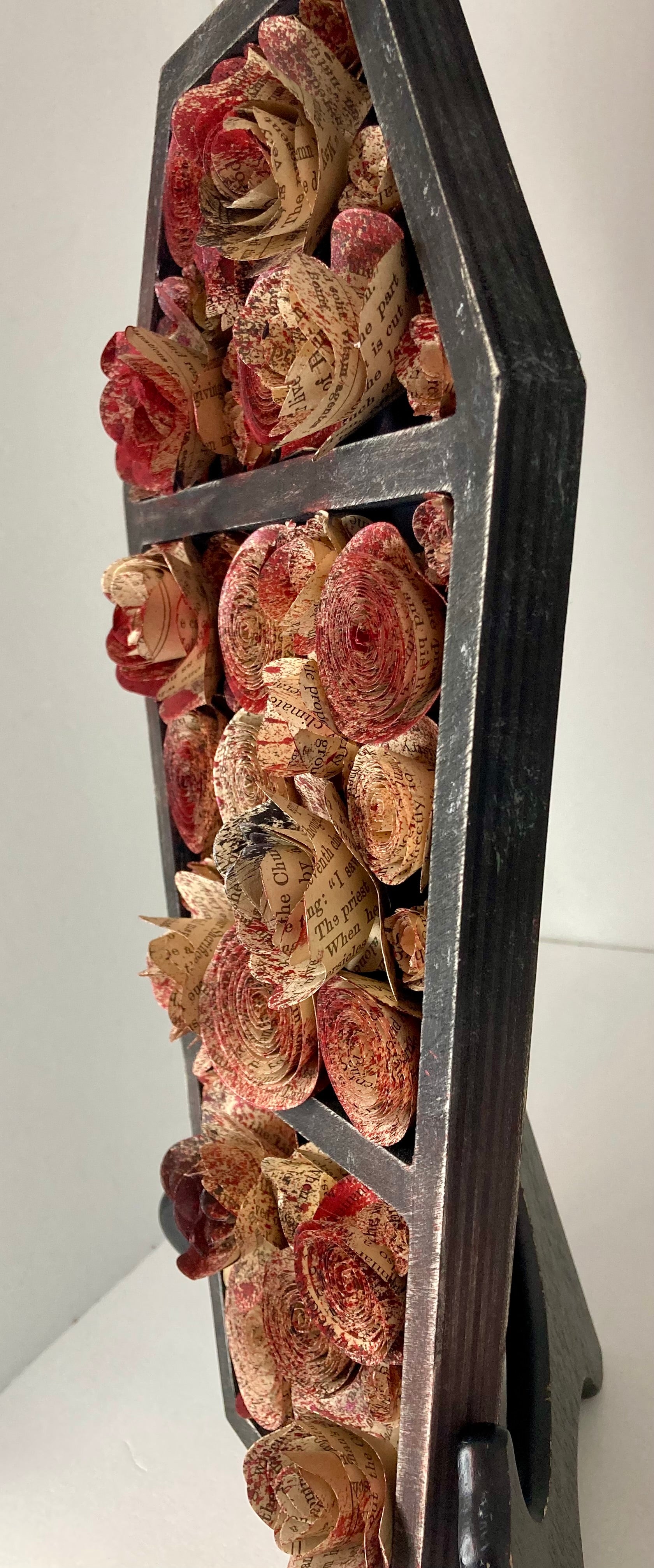 Coffin with blood splattered book roses