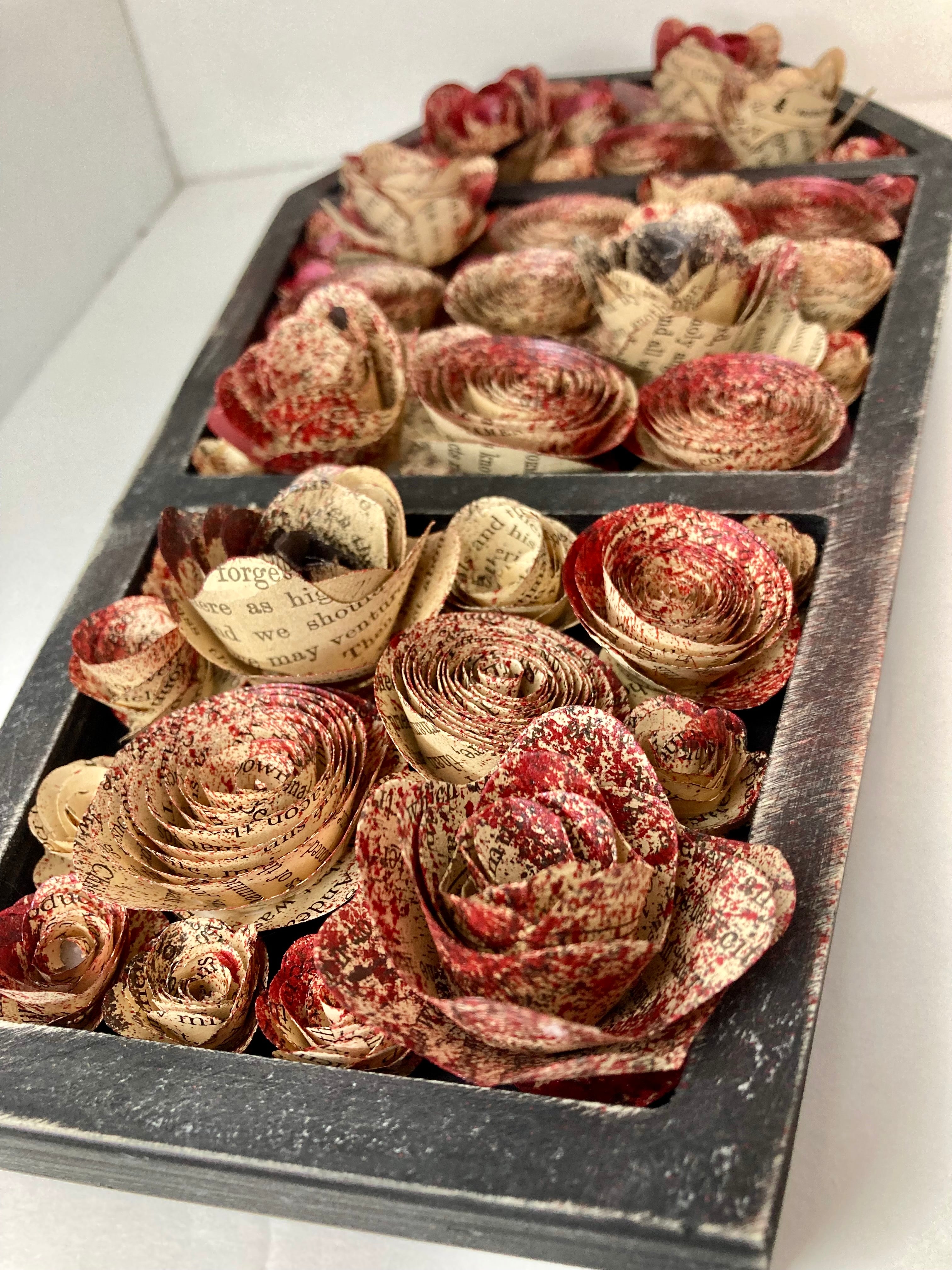 Coffin with blood splattered book roses