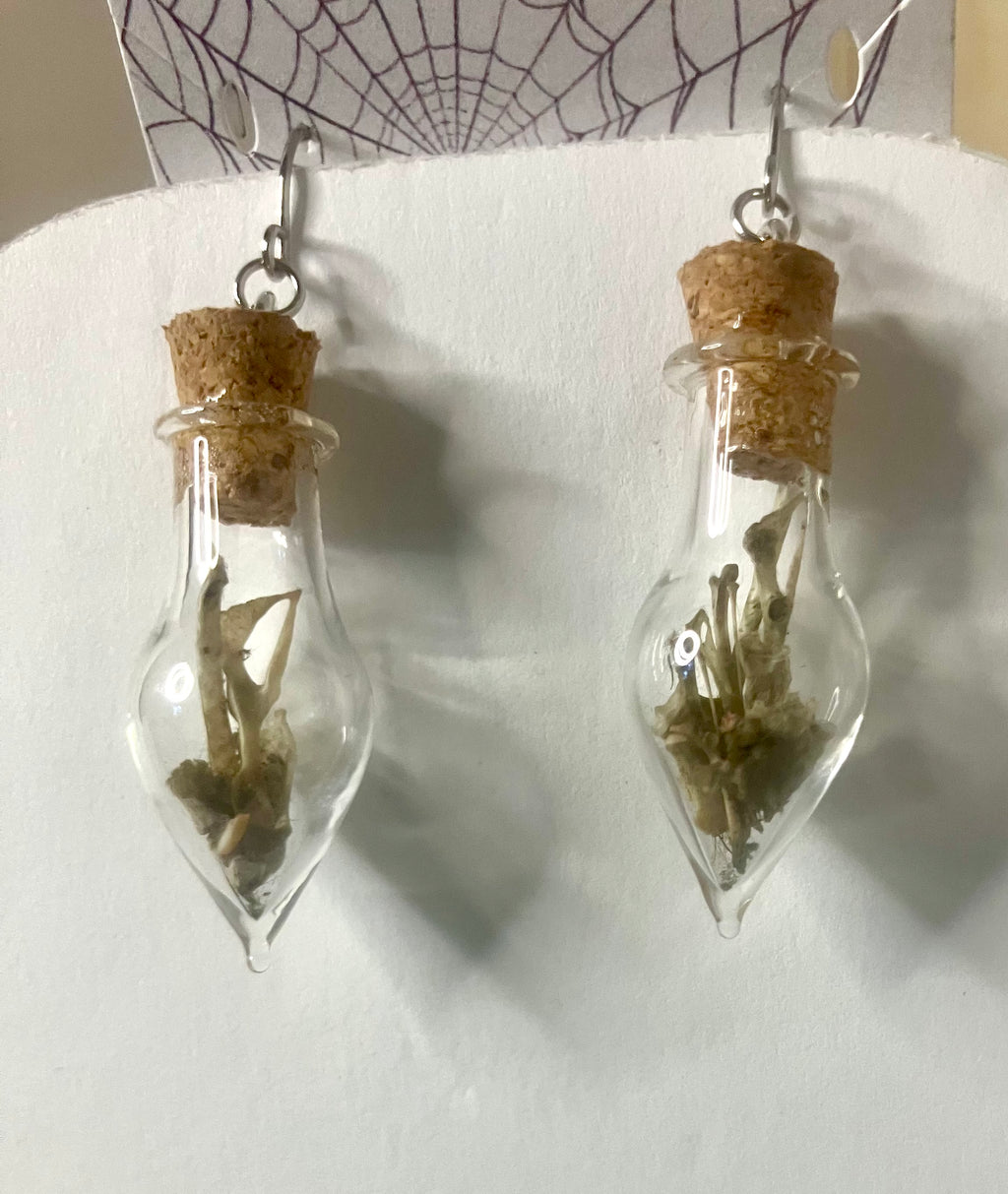 Tiny bone filled vial earrings