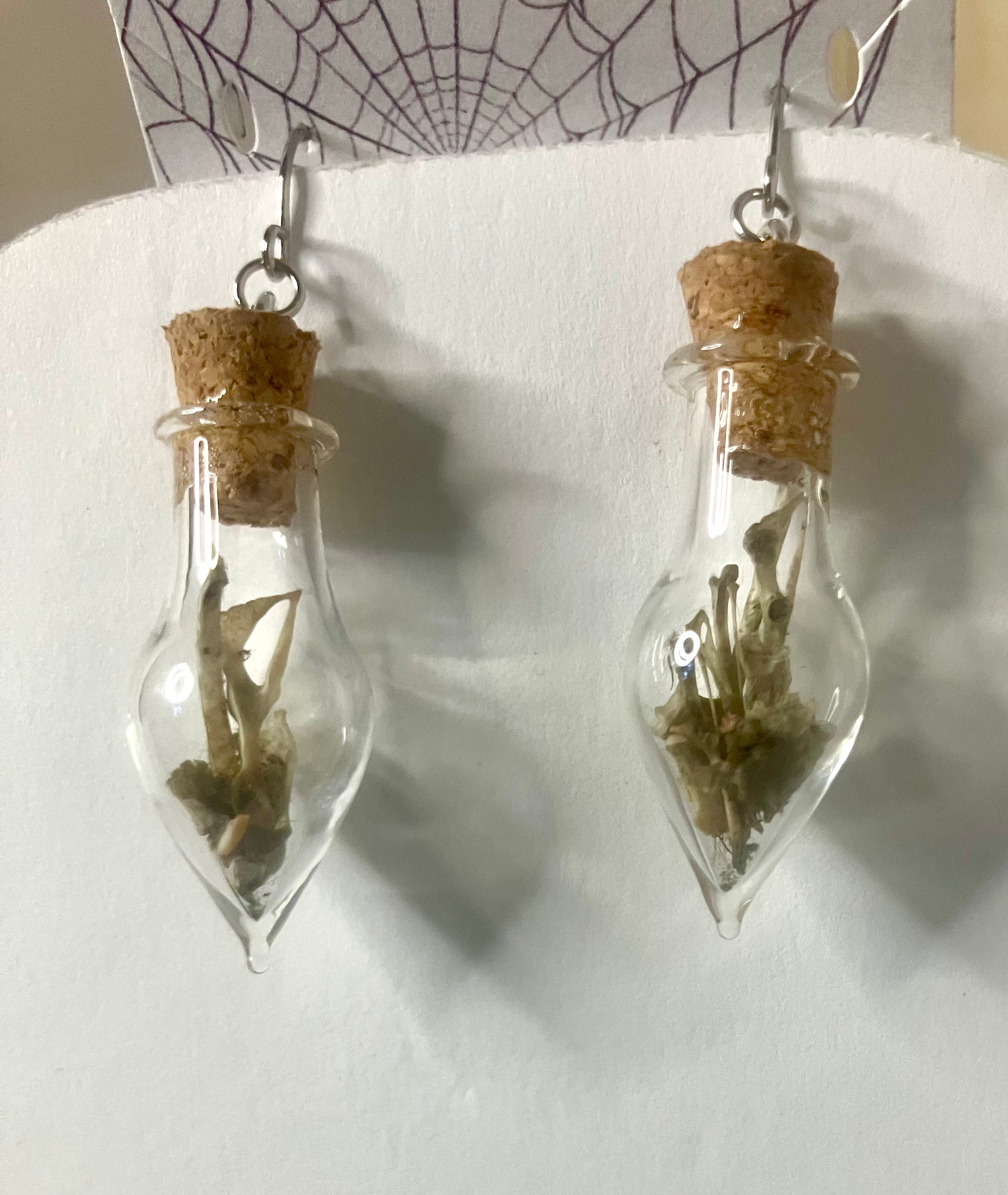 Tiny bone filled vial earrings